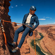 Climber rappelling a red-rock canyon wall on an orange rope, Adrenaline experience gift