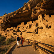 Two visitors gazing up at ancient cliff-dwelling ruins, Archaeological & Ruins Tours Experience Collection experience gift