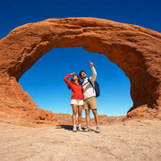 Couple gazing up at a red sandstone arch in Utah, Arches & Canyonlands Tour experience gift