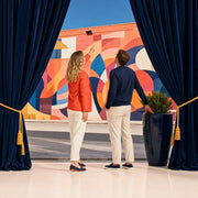 Couple admiring a vivid street mural in a sunlit arts district, Arts & Culture experience gift