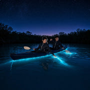 Tandem kayak drifting a glowing lagoon under the stars, Bioluminescence Tours experience gift