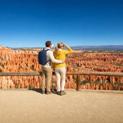 Couple at the rim taking in glowing orange hoodoo spires, Bryce Canyon National Park Tour experience gift
