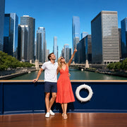 Couple on an open boat deck pointing up at the towers of the Chicago River, Chicago Bucketlist experience gift