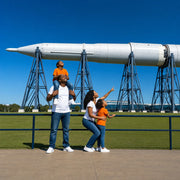 Family beneath a giant display rocket, boy on dad's shoulders, Houston Bucketlist Experience Collection experience gift