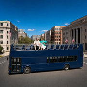 Couple sightseeing from the open top deck of a double-decker bus, Bus & Hop-On Hop-Off Tours experience gift