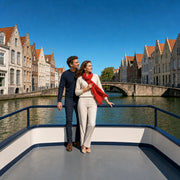 Couple on a canal boat deck watching gabled facades and an arched footbridge, Canal Cruise experience gift