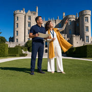 Couple with audio guides on the lawn of a grand castle-like estate, Castle & Palace Tours experience gift