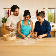 Instructor and student pleating dumplings side by side at a floured counter, Chinese Dumpling Class experience gift