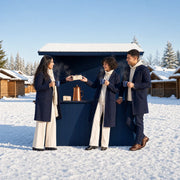 Three friends swapping a gift over cocoa at a snowy market stall, Secret Santa experience gift