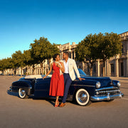 Couple beside a gleaming navy convertible in golden evening light, Classic Car Tour experience gift