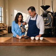 Roaster pouring brewed coffee into a visitor's cup at the counter, Coffee Tasting & Tour experience gift