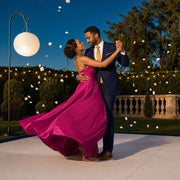Couple dancing on a garden dance floor as petals drift by, First Dance experience gift