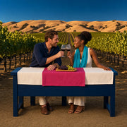 Couple clinking wine glasses at a vineyard tasting bench at sunset, Our Bucketlist experience gift