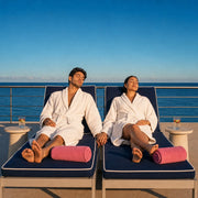 Couple in robes holding hands on twin spa loungers by the sea, Spa Day experience gift