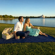 Couple picnicking on a blanket beside the Tidal Basin at evening, Date Night in Washington DC experience gift