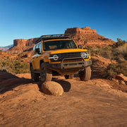 Driver steering a 4x4 up a rocky desert trail at sunset, Off Road Driving experience gift