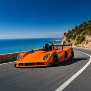 Helmeted driver cornering an orange GT race car above the sea, Thrill rides experience gift