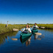 Guide pointing out a heron as she and her guest kayak a still marsh channel, Eco & Nature Kayak Tour experience gift
