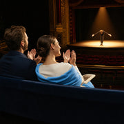 Couple applauding a performer taking a bow in the spotlight, Curtain Call experience gift