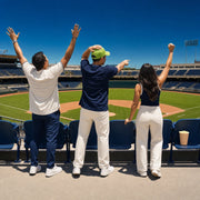 Three friends leaping to their feet mid-cheer in sunlit ballpark stands, Sports Action experience gift