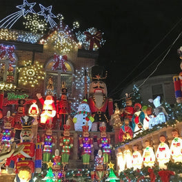 Street lit with festive displays and nutcracker figures on a winter evening walking tour