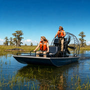 Airboat skimming Everglades saw grass with captain and passenger aboard, Everglades National Park Tour experience gift