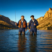 Father and adult son fly fishing together in a river canyon at evening, Outdoor Escape experience gift