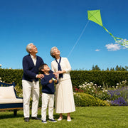 Grandparents helping their grandchild fly a lime kite on a garden lawn, Together Time experience gift