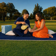 Couple sharing an evening picnic on a blanket in a park, Family Day experience gift