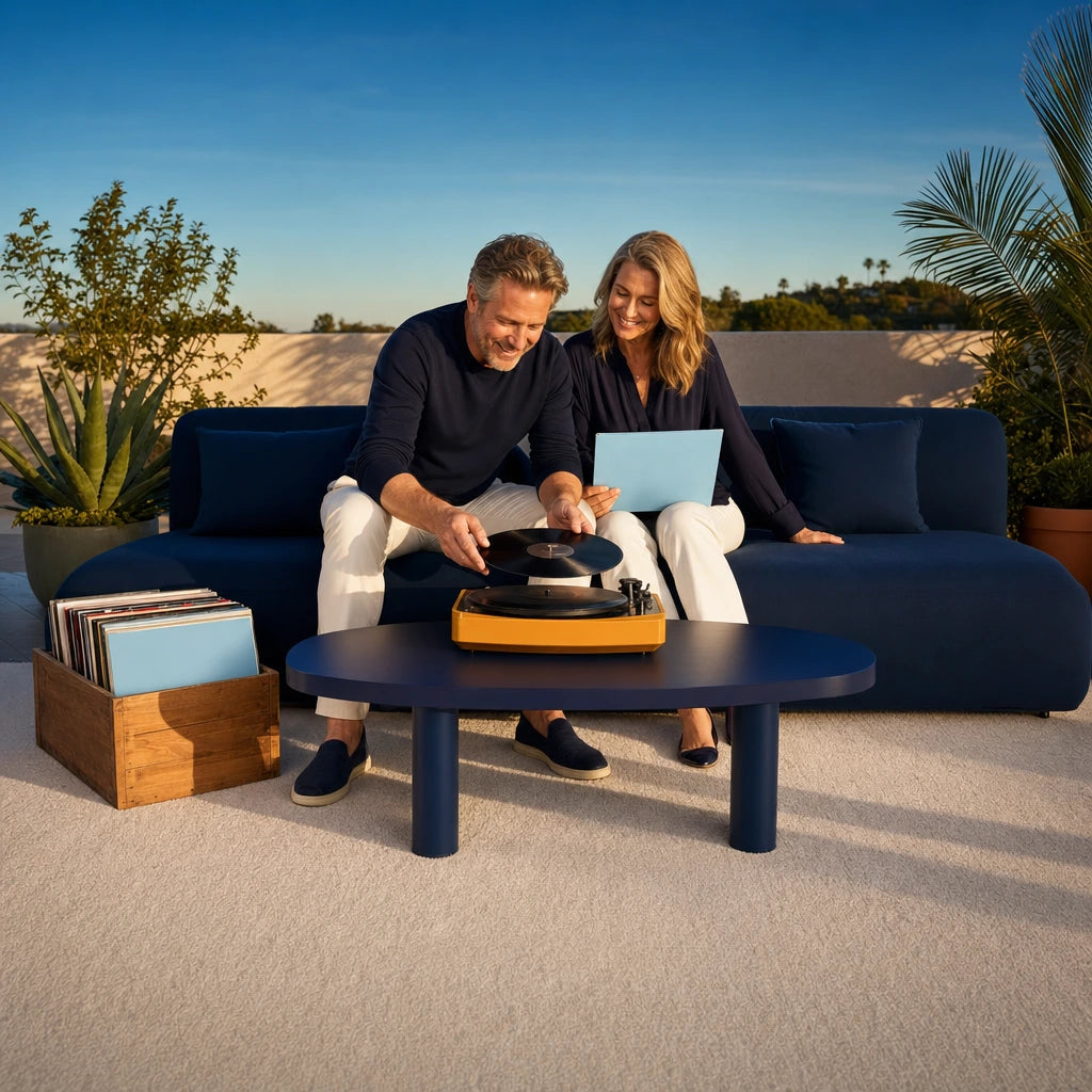 Couple playing vinyl records together on a terrace at evening, Memory Lane experience gift