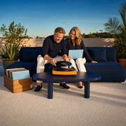 Couple playing vinyl records together on a terrace at evening, Memory Lane experience gift