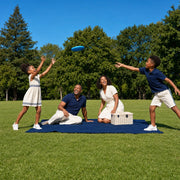 Family of four playing frisbee during a picnic in a sunlit park, We Are Family experience gift