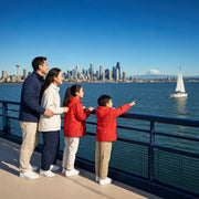 Family at a Puget Sound ferry rail with the Seattle skyline, Family Fun in Seattle Experience Collection experience gift