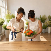 Instructor and student arranging ranunculus at a flower studio table, Flower Arranging experience gift