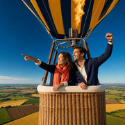 Couple cheering in a hot air balloon basket over farmland, Air Adventure experience gift
