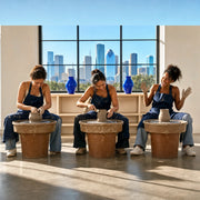 Three friends throwing pottery in a sunlit Houston studio, Girls Day Out in Houston Experience Collection experience gift