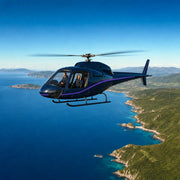 Pilot and passenger flying over a blue coastline with green headlands below, Helicopter Sightseeing Tour experience gift