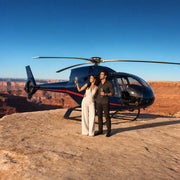 Couple toasting beside a landed helicopter on a canyon rim, Helicopter Tour with Landing experience gift