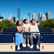Family on a sightseeing bus top deck craning up at a passing tower, Hop-On Hop-Off Bus Tour experience gift