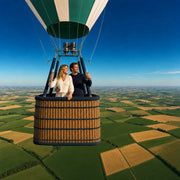 Couple toasting with champagne in a balloon basket high over farmland, Hot Air Balloon with Champagne experience gift