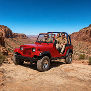Guided red 4x4 crawling a boulder ledge in a red-rock canyon, Jeep & 4x4 Tours experience gift