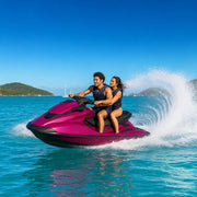 Couple riding a jet ski across an open bay with spray behind, Jet Ski Rides experience gift