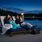 Family settling onto dock loungers at dusk, child under a throw, Family Getaway experience gift