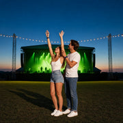 Woman with arms raised beside her partner in a concert crowd, Live Music & Concerts experience gift