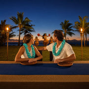 Couple in orchid leis watching a luau at a torch-lit feast table, Luau & Cultural Shows experience gift