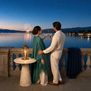 Couple toasting champagne on a lakeside terrace as fireworks bloom, Iconic Fourth of July Luxe experience gift