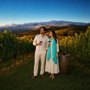 Couple raising wine glasses in a foggy vineyard row at dusk, San Francisco Iconic Bucketlist Luxe experience gift
