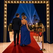 Couple stepping onto a red carpet as searchlights sweep the dusk sky, Iconic Showtime Luxe experience gift
