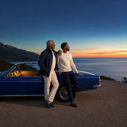 Father and adult son leaning on a convertible at a dusk coastal overlook, Iconic Dad's Choice Luxe experience gift