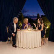 Parents and adult daughter at a lantern-lit garden dinner at dusk, Iconic Family Time Luxe experience gift